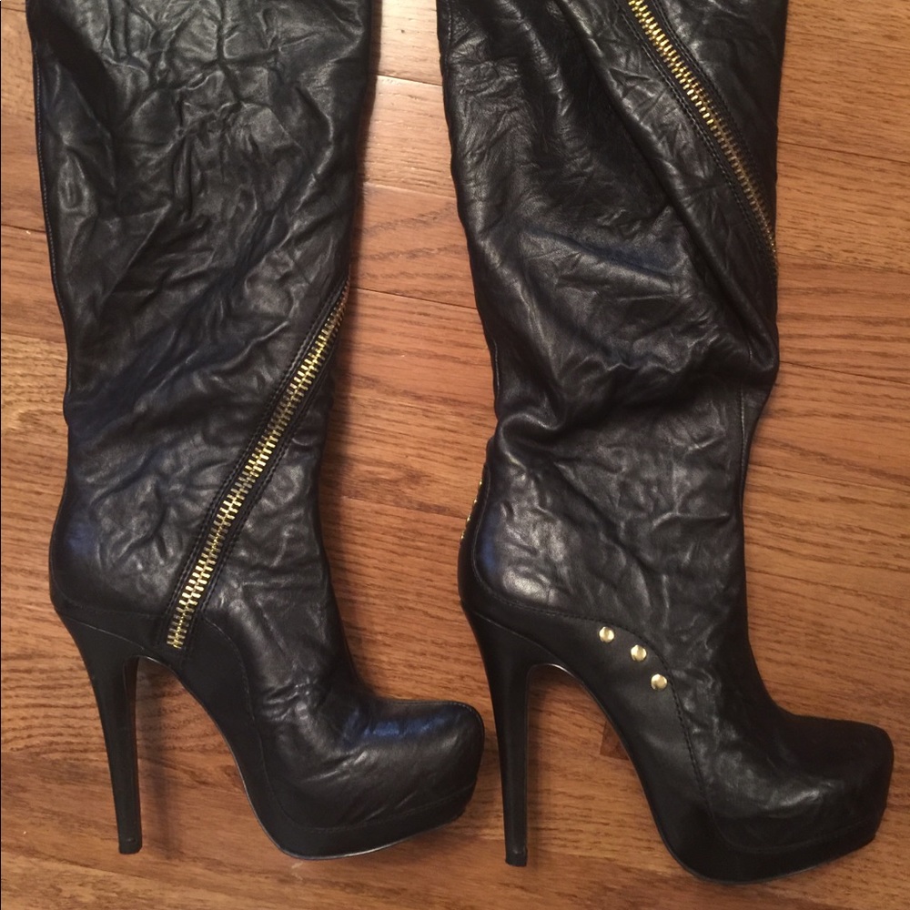 Black leather boots with gold zipper detail